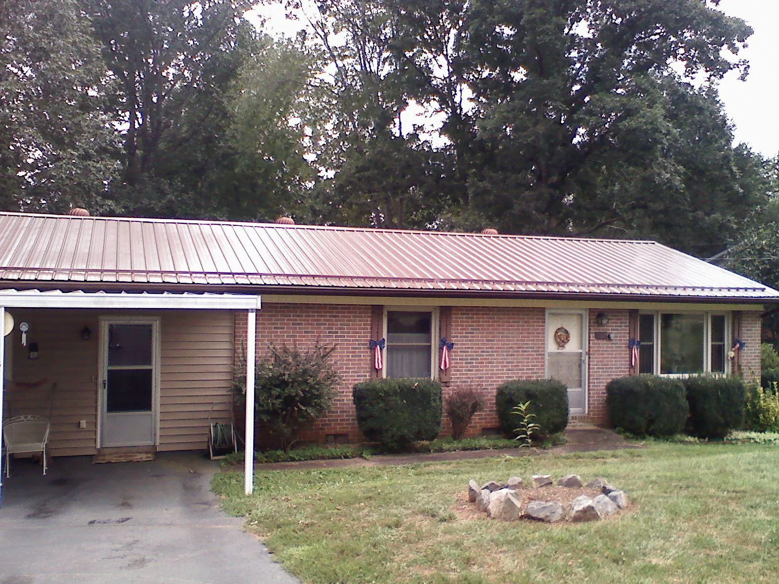 Bronze metal roof and carport on a brick ranch home — Roof Repair work by our crew in Jamieson